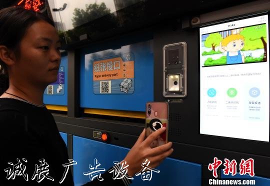 圖為市民感受用智能垃圾箱掃碼扔垃圾?！≈芤?攝